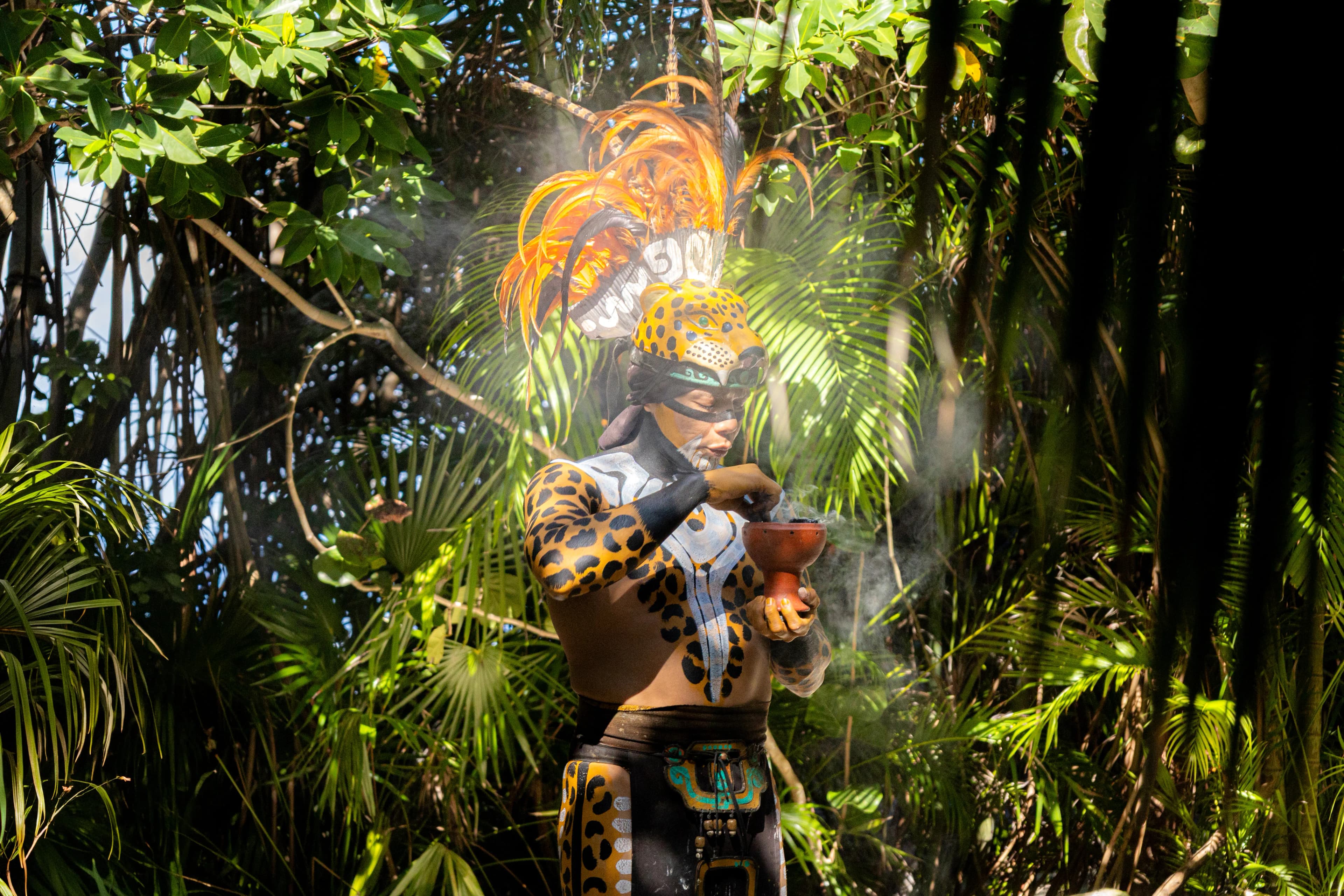 Mayan ceremony surrounded by tropical greenery